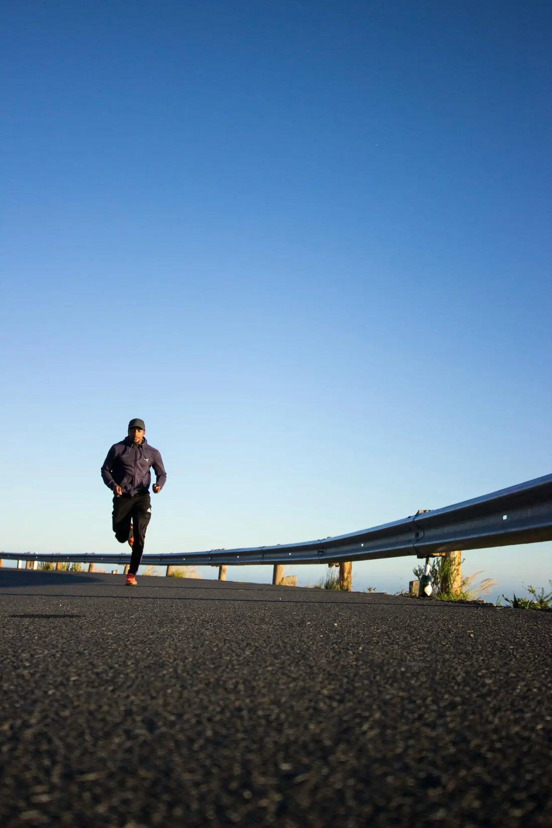 man running on concrete road in the morning