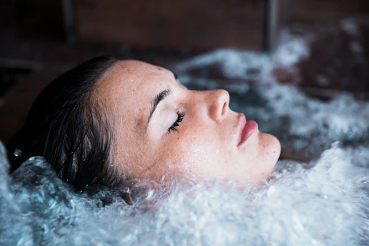 Woman taking a cold plunge before bed for cold water immersion therapy