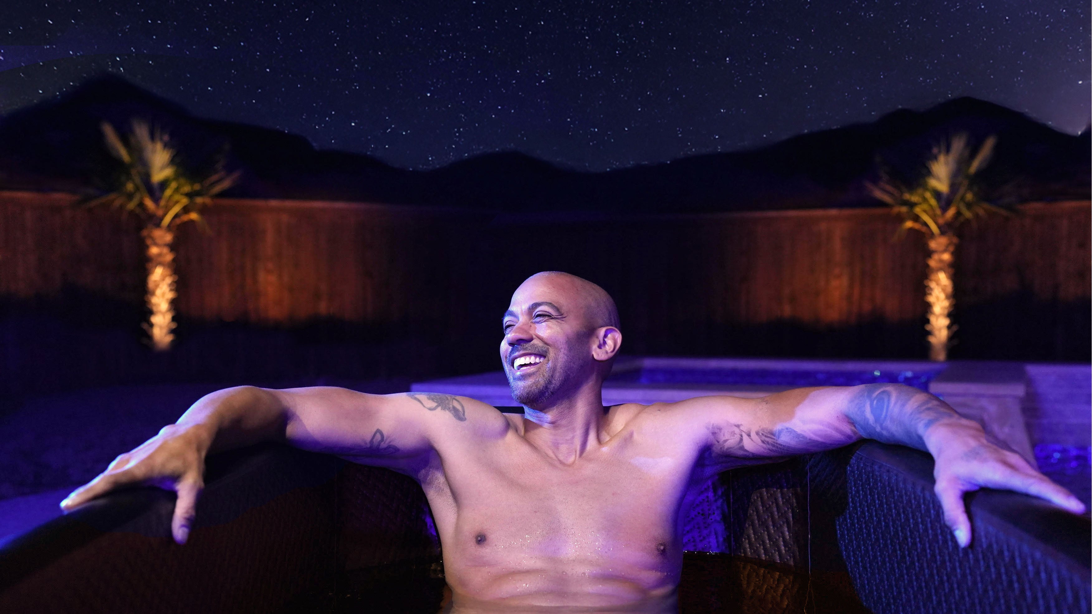 Man sitting in cold plunge at night